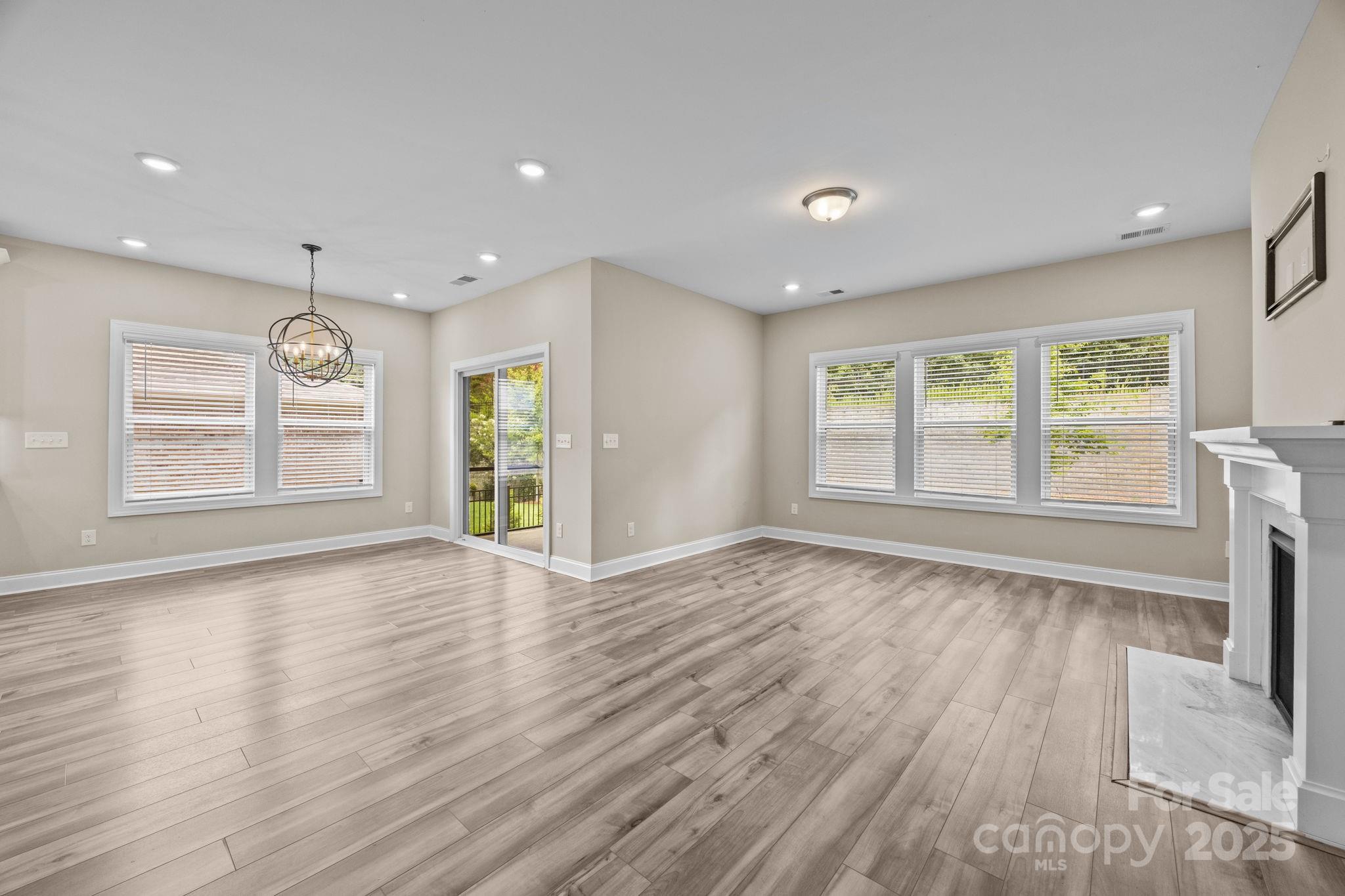 5240 Birchhill Road Mint Hill, NC 28227 - Photo 31 of 48 a view of an empty room with wooden floor and a window