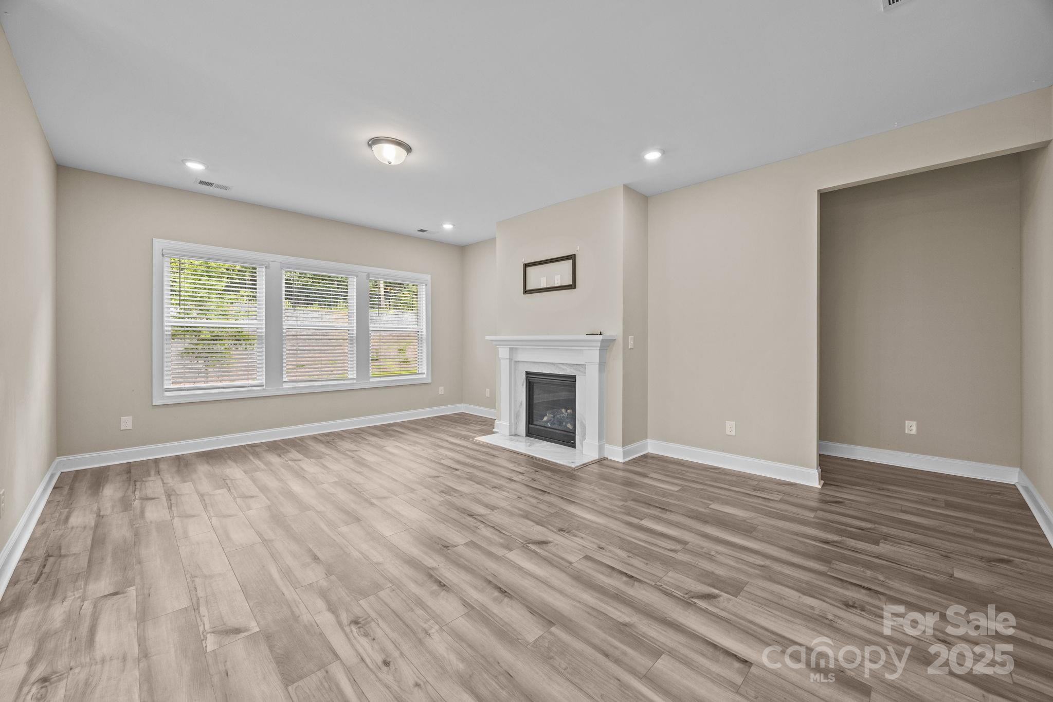 5240 Birchhill Road Mint Hill, NC 28227 - Photo 32 of 48 a view of empty room with wooden floor and fireplace