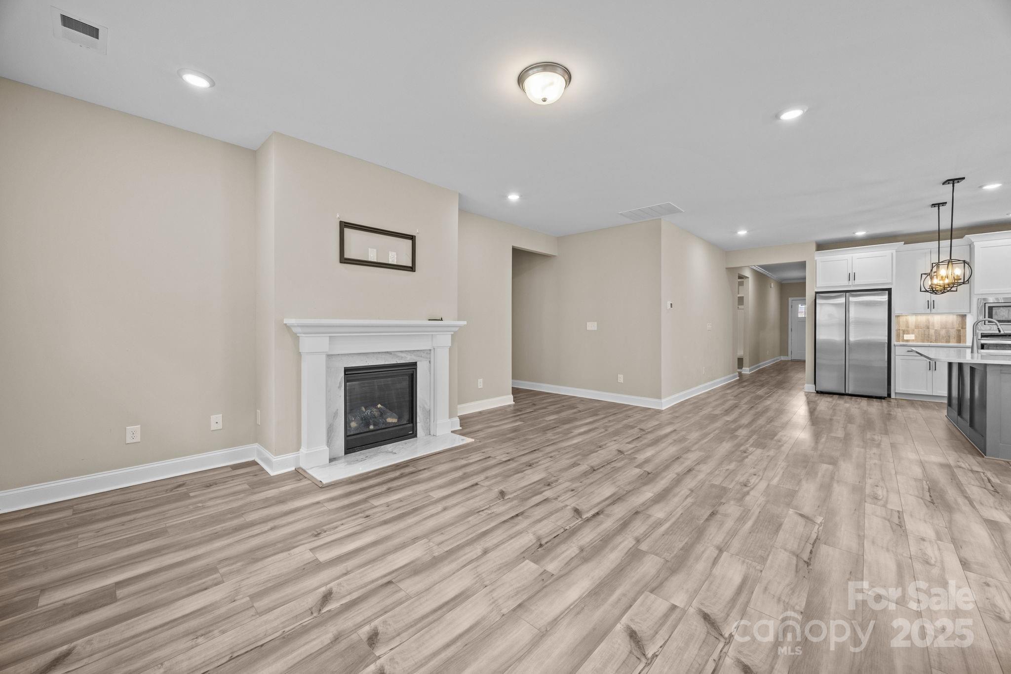 5240 Birchhill Road Mint Hill, NC 28227 - Photo 33 of 48 a view of a livingroom with a fireplace and wooden floor