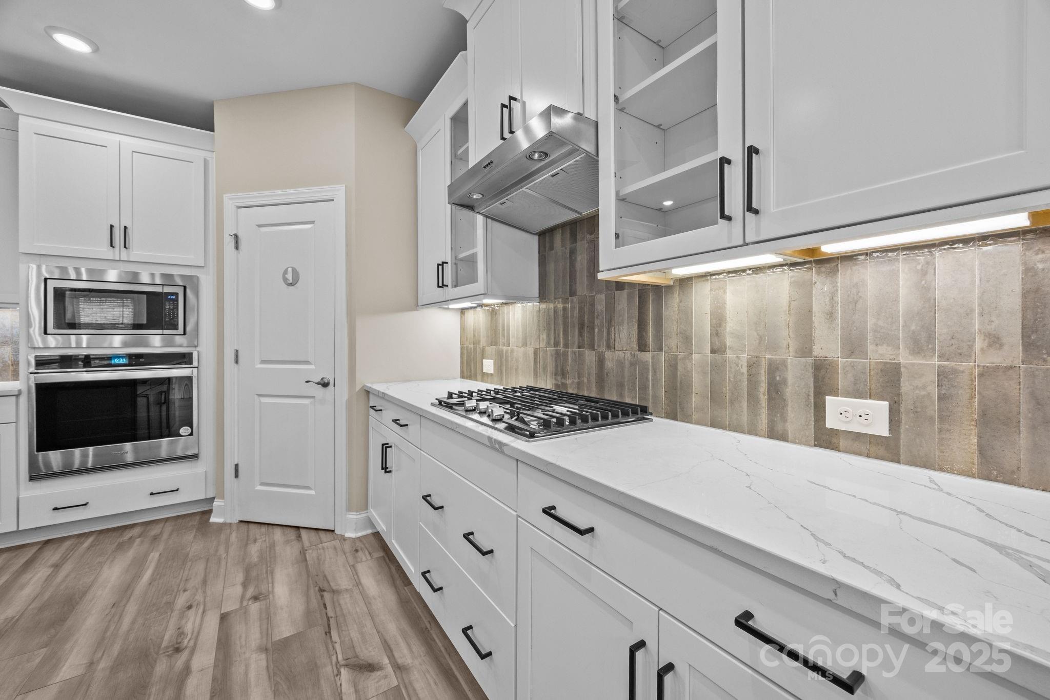 5240 Birchhill Road Mint Hill, NC 28227 - Photo 38 of 48 a kitchen with granite countertop a stove and a white cabinets