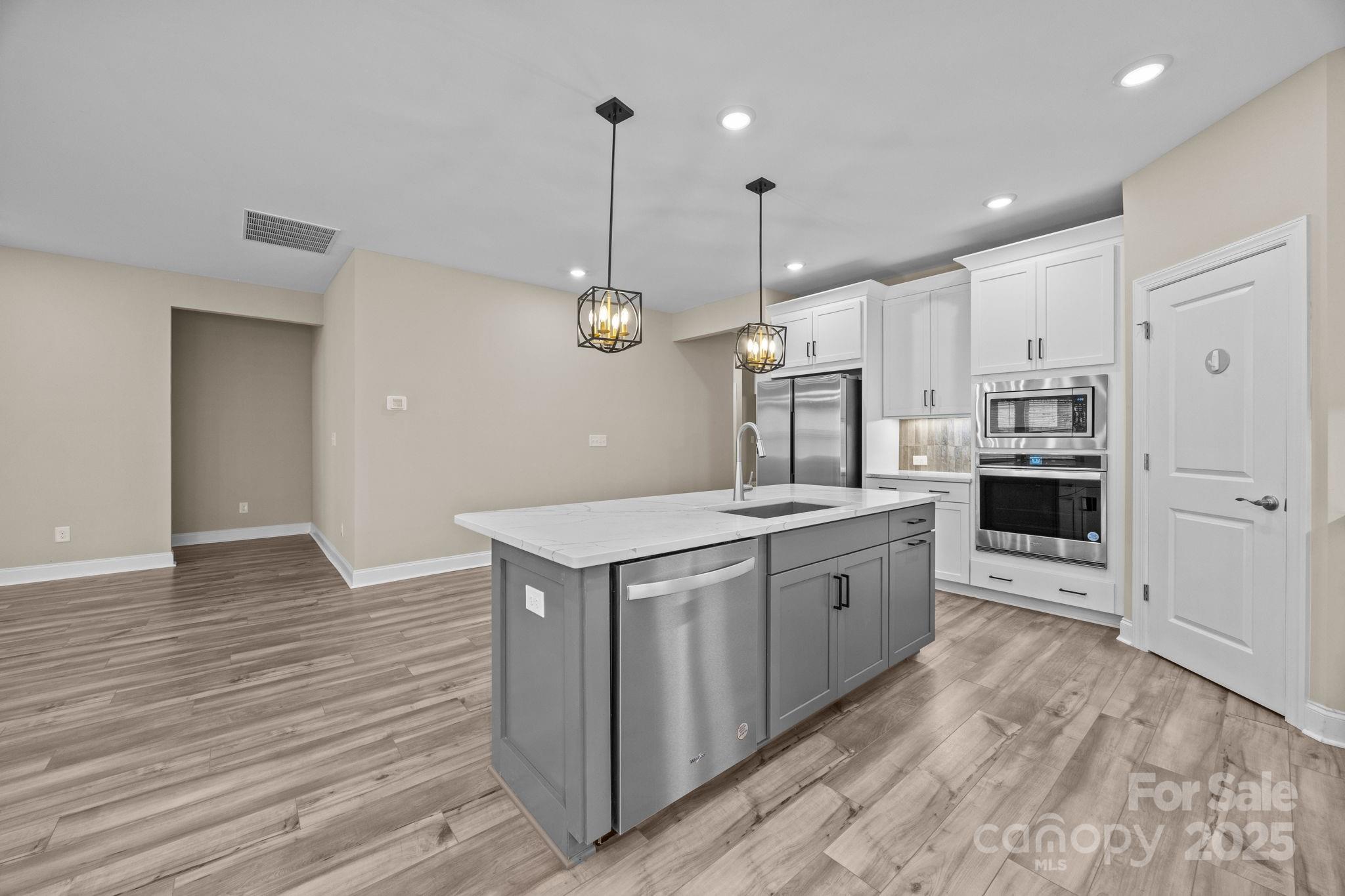 5240 Birchhill Road Mint Hill, NC 28227 - Photo 39 of 48 a large kitchen with stainless steel appliances kitchen island granite countertop a stove and a refrigerator