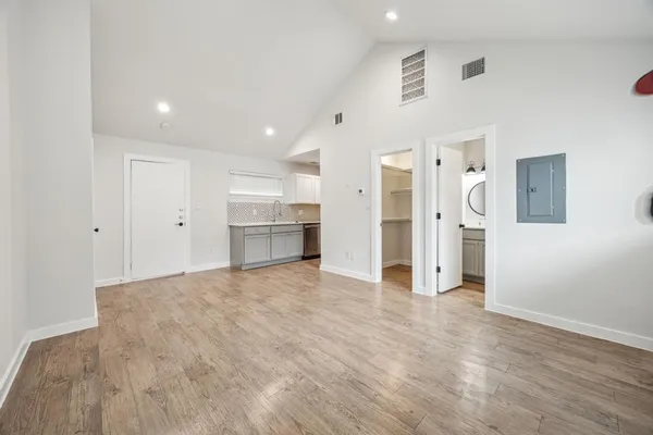 a view of empty room with wooden floor