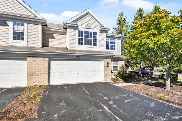 a view of a house with a yard and garage