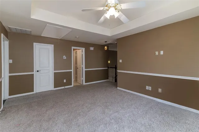 an empty room with closet and windows