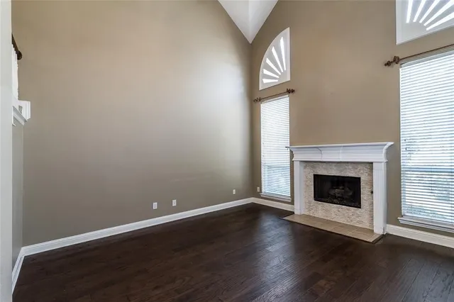 a view of a livingroom with wooden floor and a fireplace