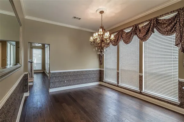 a view of a livingroom with wooden floor and a large window
