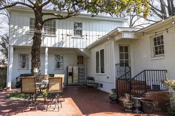a view of a patio with a table and chairs and floor to ceiling window