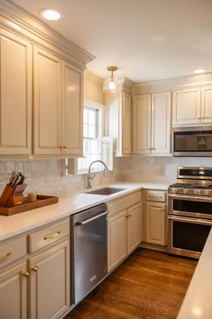 a bedroom with a bed and a dresser next to a window