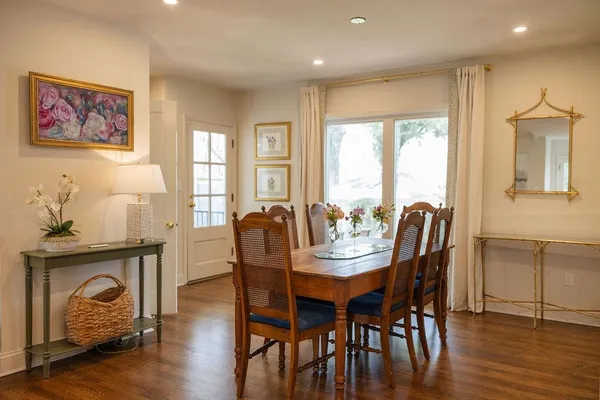 a view of a a dining room with furniture window and wooden floor