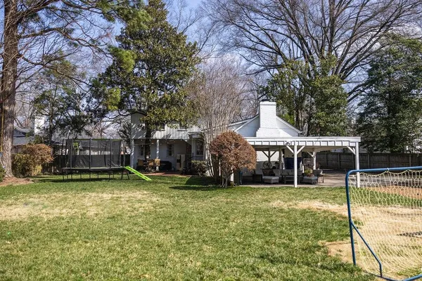 a view of a house with a yard and sitting area