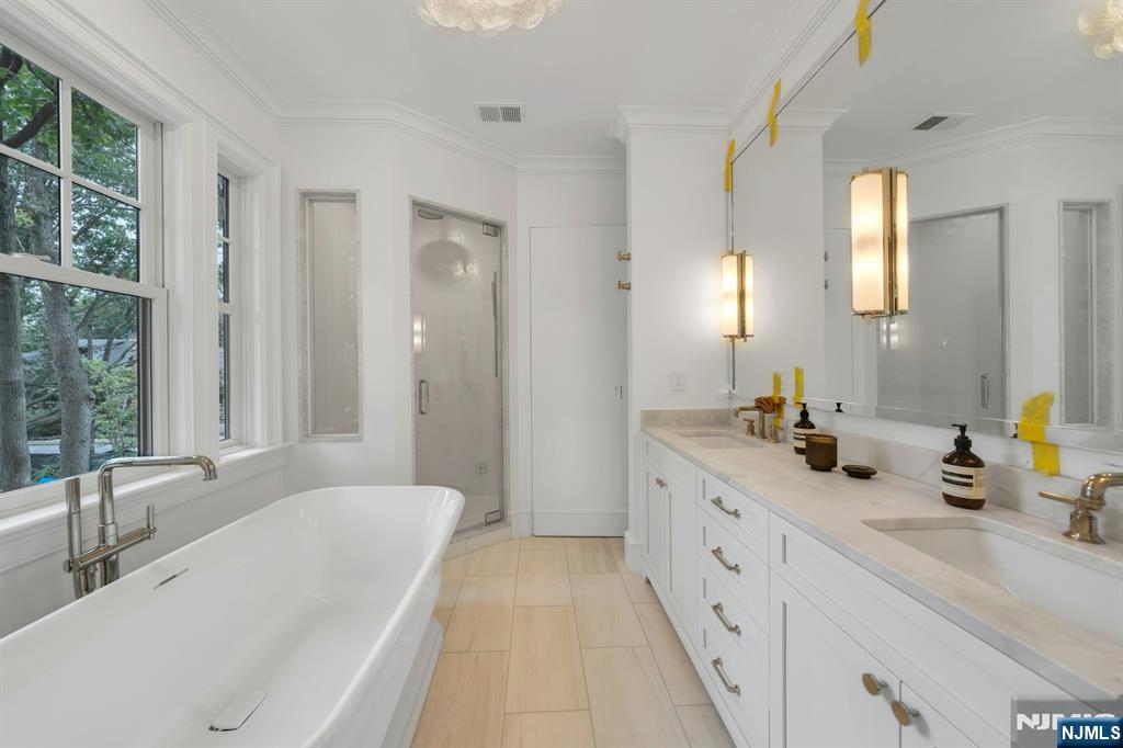 84 Watchung Avenue Montclair, NJ 07043 - Photo 28 of 48 a spacious bathroom with sinks double vanity and a bathtub