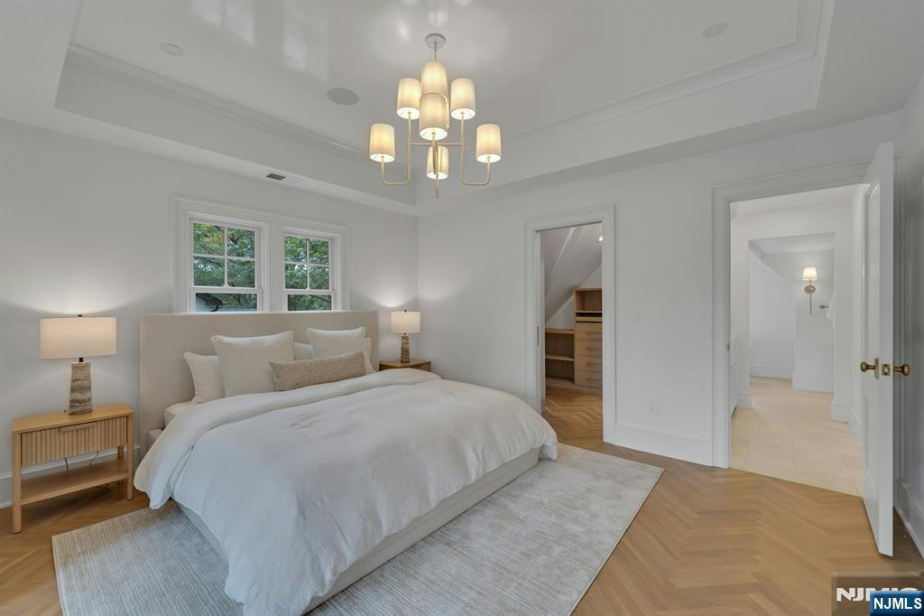 84 Watchung Avenue Montclair, NJ 07043 - Photo 33 of 48 a bedroom with a large bed and a chandelier