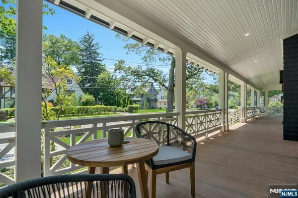 a view of a house with a yard and sitting area