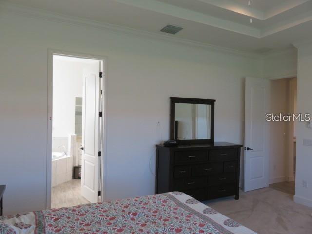6915 Indus Valley Circle Parrish, FL 34219 - Photo 11 of 38 a bedroom with a bed and a bathroom