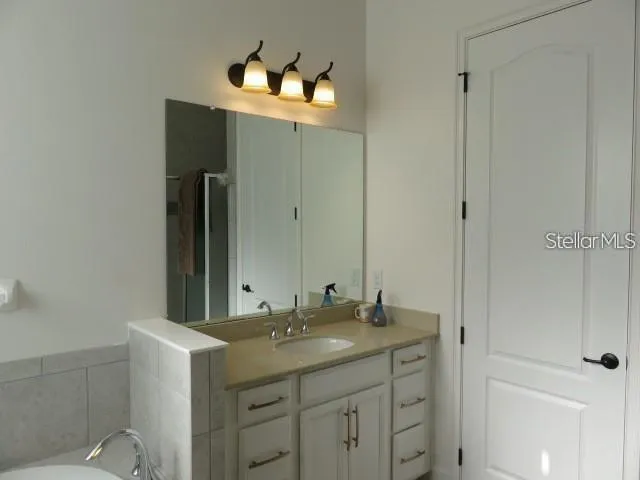 a bathroom with a double vanity sink and mirror