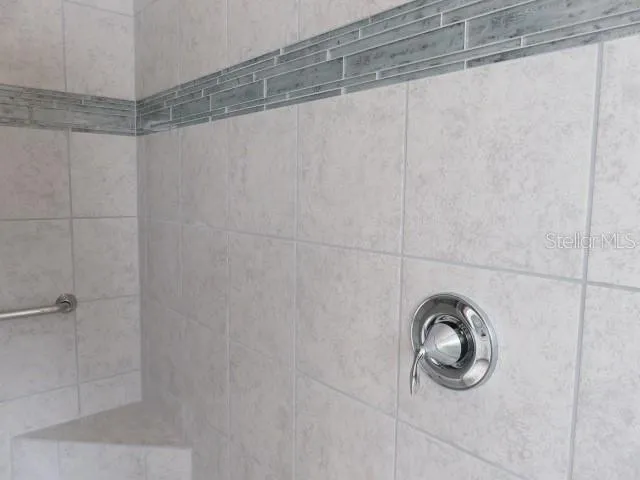 a bathroom with a shower and a window