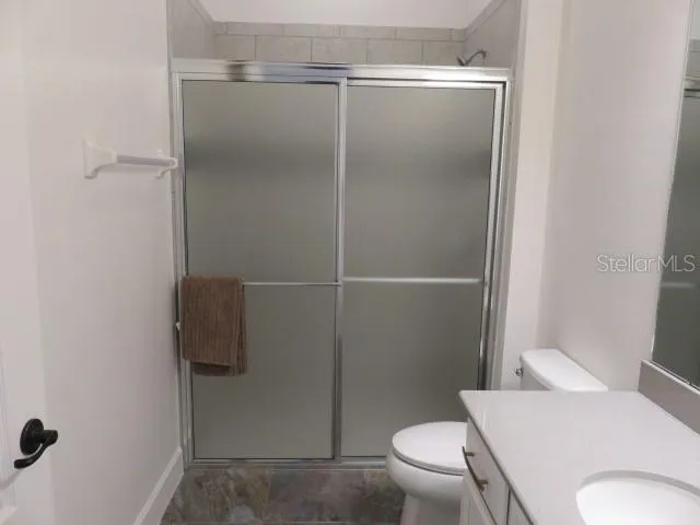 a bathroom with a toilet and a shower