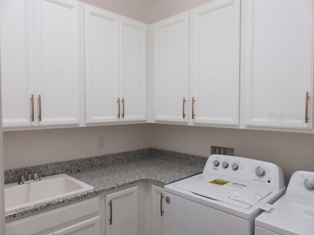 6915 Indus Valley Circle Parrish, FL 34219 - Photo 24 of 38 a utility room with dryer and washer