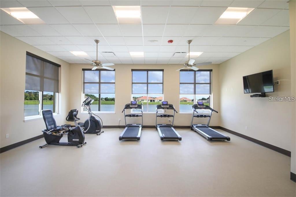 6915 Indus Valley Circle Parrish, FL 34219 - Photo 35 of 38 a living room with furniture window and a flat screen tv