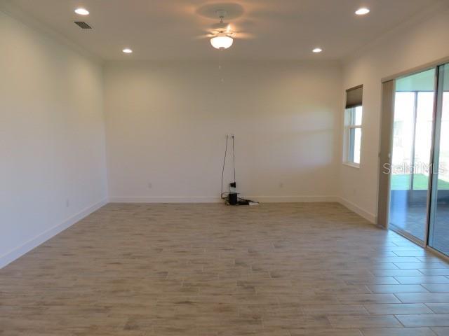 6915 Indus Valley Circle Parrish, FL 34219 - Photo 6 of 38 a view of a room with wooden floor and window