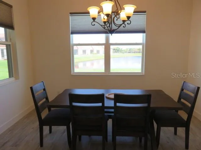 a dining room with wooden floor and breakfast area