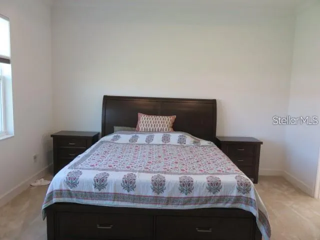 a bedroom with a bed and window