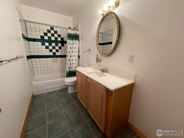 a bathroom with a sink mirror toilet and shower