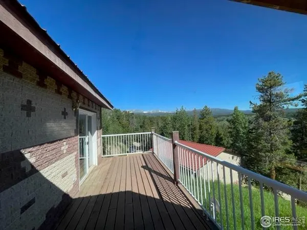 a view of balcony with wooden floor and fence