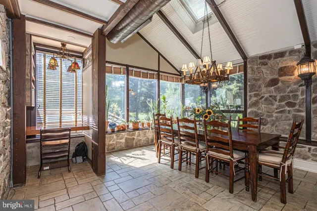 a view of a dining room with furniture large windows and wooden floor