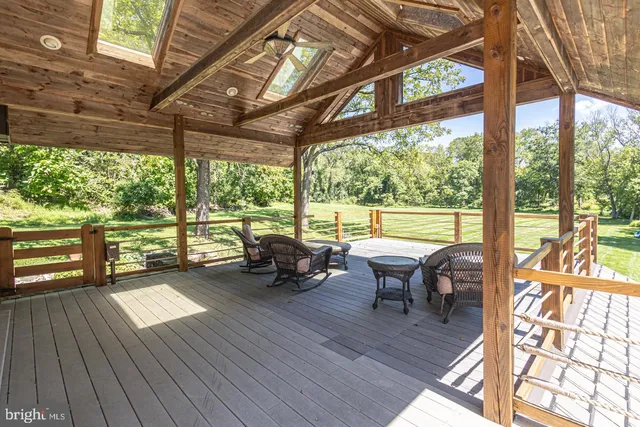 a view of a patio with chairs and wooden floor