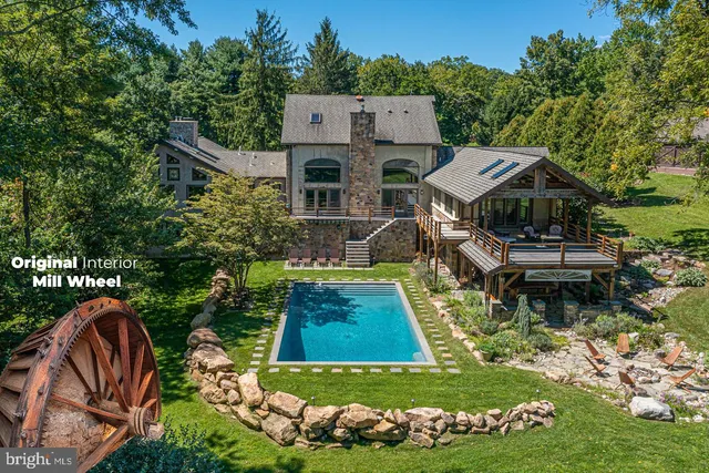 a aerial view of a house with swimming pool garden and patio