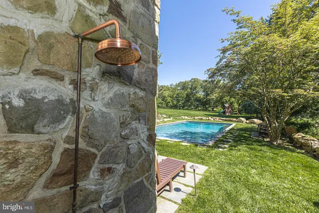 a view of a house with backyard and sitting area
