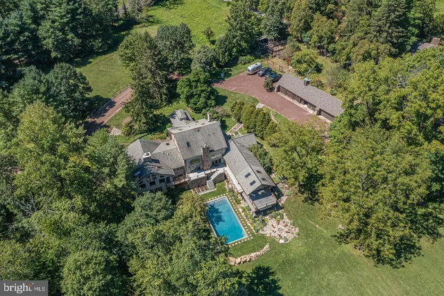an aerial view of a house with outdoor space and a lake view