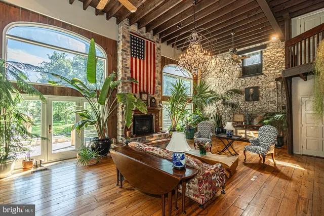 a outdoor space with patio the couches and a dining table with wooden floor