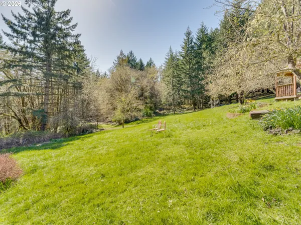 a view of a yard with a house in the background