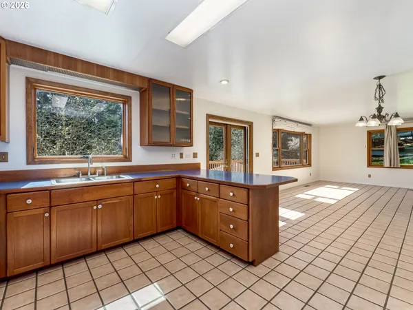 a spacious bathroom with a granite countertop sink and a large mirror