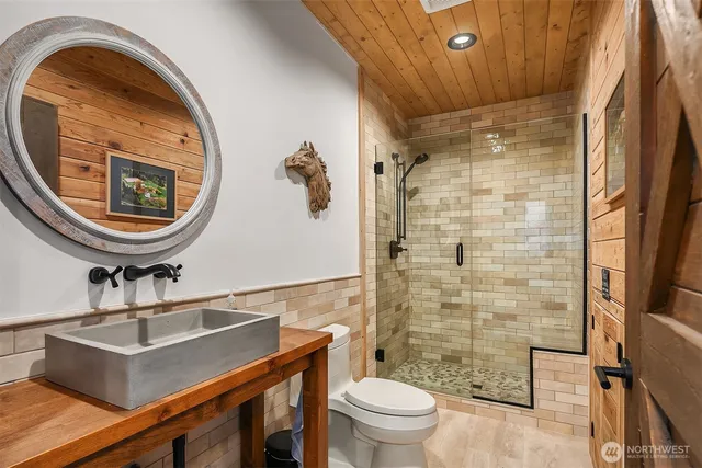 a bathroom with a sink a toilet and a mirror