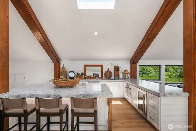 a dining room with furniture and a large window