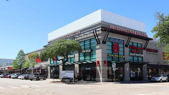 a front view of multi story residential apartment building with retail shops