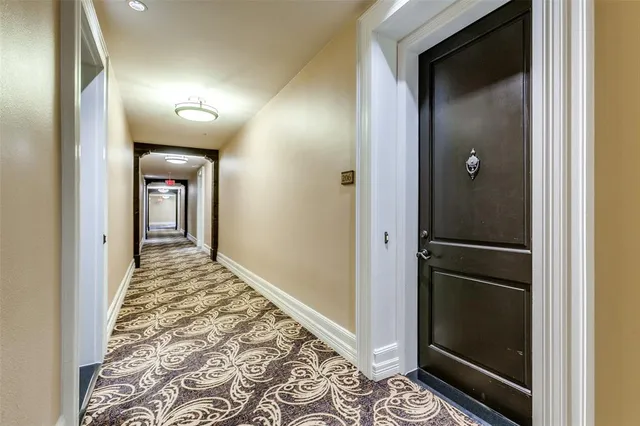 a view of hallway with wooden floor