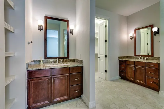 a spacious bathroom with a granite countertop sink and a mirror