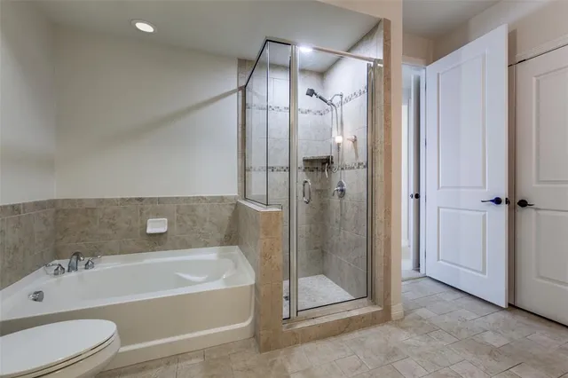 a bathroom with a bathtub a toilet and a shower