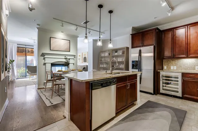 a kitchen with stainless steel appliances granite countertop a stove and a refrigerator