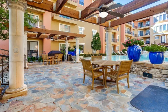 a view of a patio with a dining table and chairs