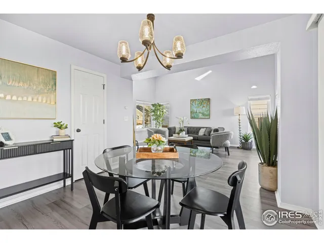 a view of a dining room with furniture and a chandelier