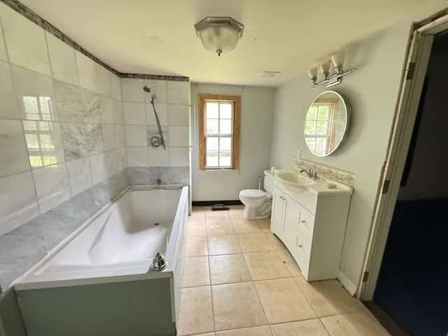 a bathroom with a sink a toilet and bathtub