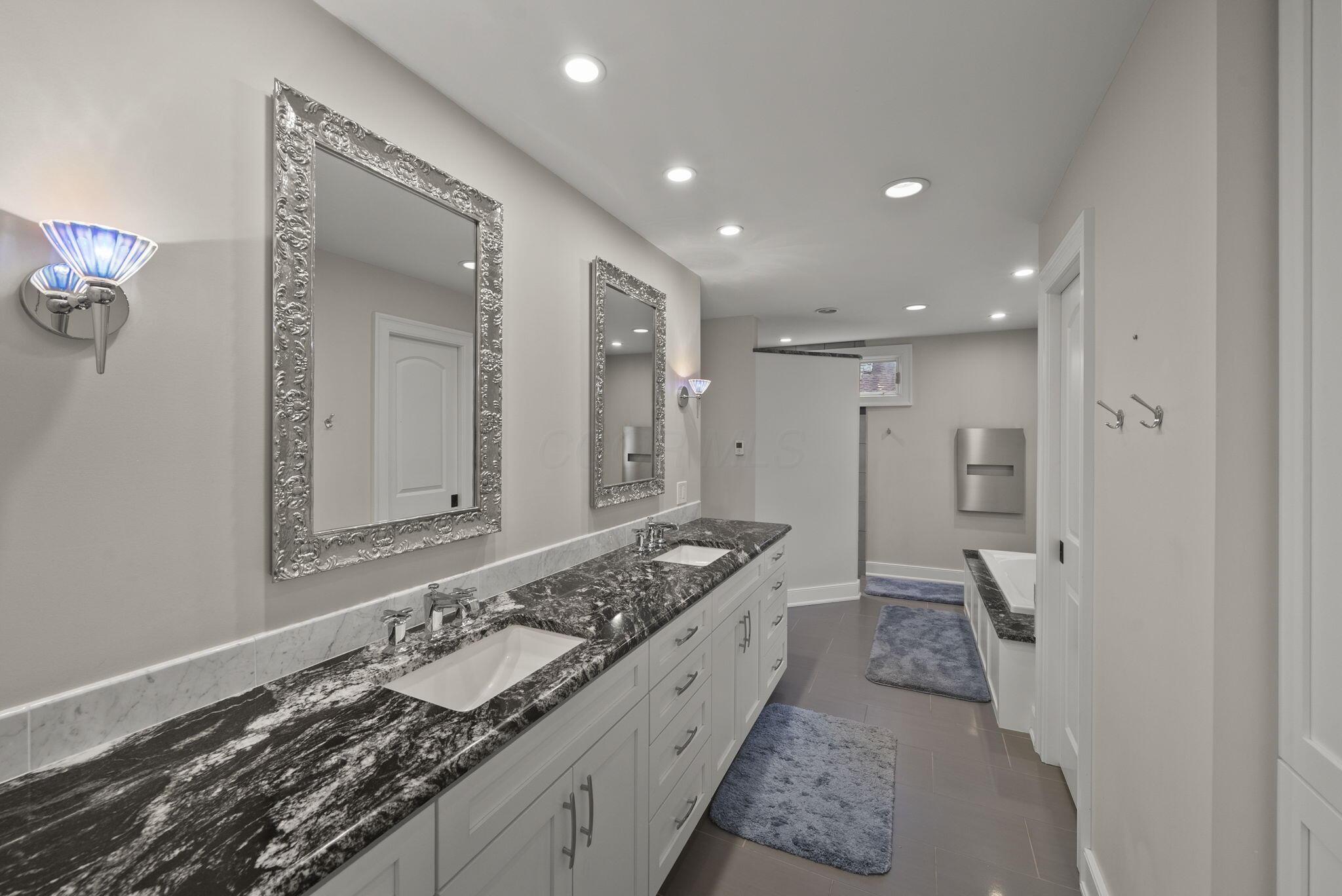 1851 Berkshire Road Columbus, OH 43221 - Photo 34 of 125 Primary bath, double vanity, heated floors, grantie counters, ample storage, entry to primary walk-in closet.