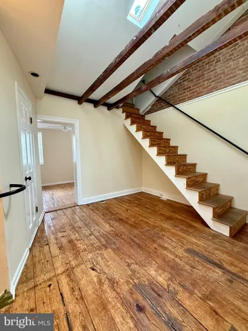 a view of an entryway with wooden floor