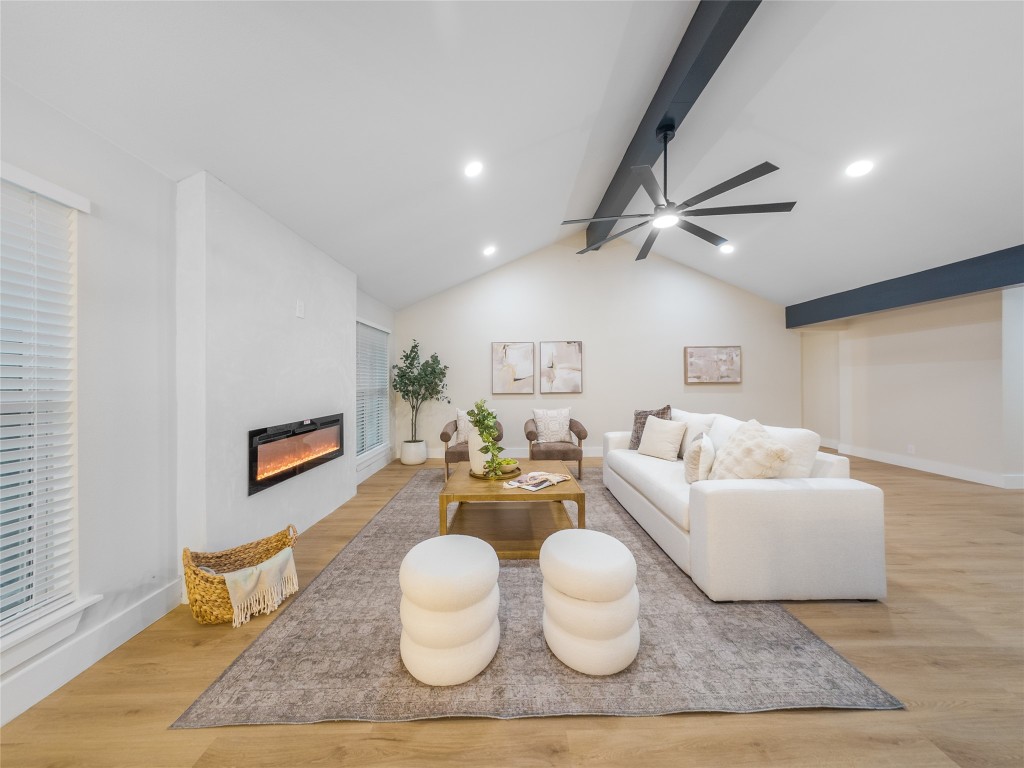 224 Clear Springs Road Georgetown, TX 78628 - Photo 11 of 32 Living room featuring light wood-type flooring, a glass covered fireplace, and recessed lighting