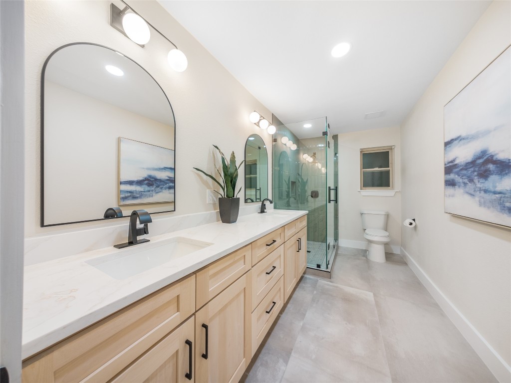 224 Clear Springs Road Georgetown, TX 78628 - Photo 22 of 32 Bathroom featuring a shower stall, double vanity, recessed lighting, and concrete floors